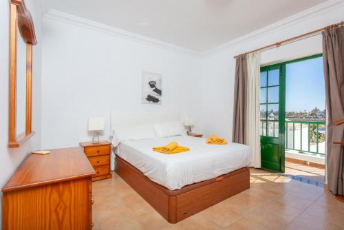 a bedroom with a bed and a large window at Villa Costa Papagayo 5 in Playa Blanca