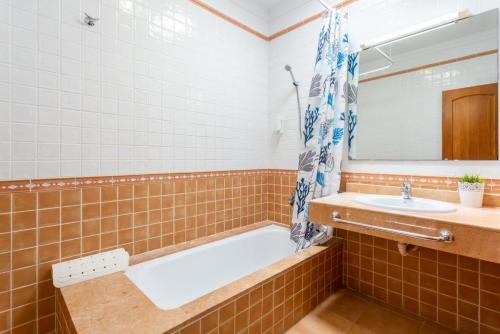 a bathroom with a tub and a sink at Villa Costa Papagayo 5 in Playa Blanca