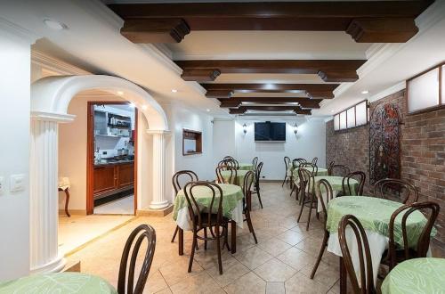 a dining room with tables and chairs in a room at Hotel Lukas in Medellín