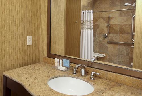a bathroom with a sink and a shower at Hampton Inn & Suites Fargo Medical Center in Fargo