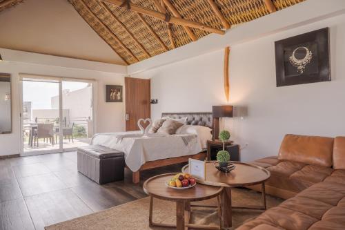 a living room with a bed and a couch at Nimue Marina Residence in Ajijic