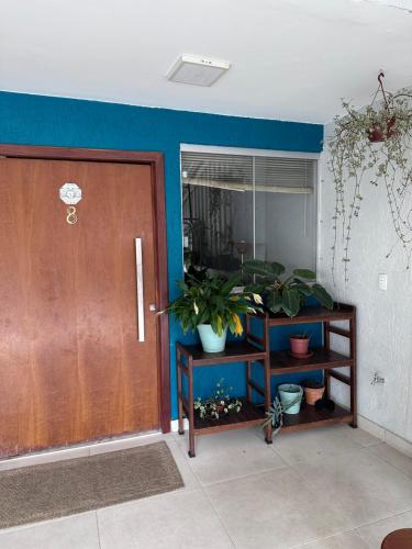 a room with a door and a plant on a shelf at GayFriendly Hostel BSB Airport in Brasilia