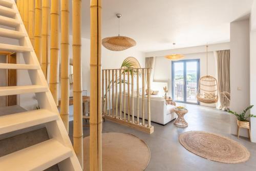 a living room with a spiral staircase and a living room at Villa Canova in Mesovoúnia