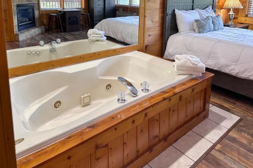 a large bath tub in a room with two beds at Reindeer Hideaway in Pigeon Forge