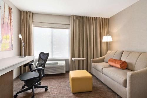 a hotel room with a couch and a desk at Hilton Garden Inn Flagstaff in Flagstaff