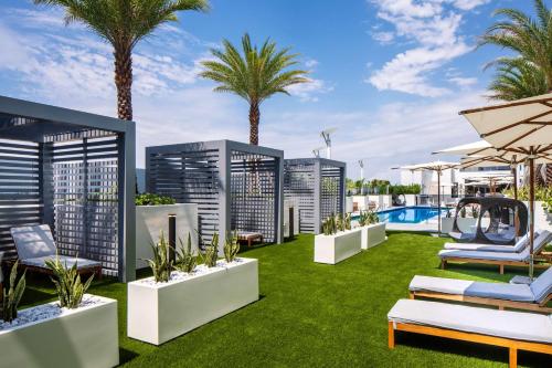 an image of the rooftop of a hotel with palm trees at Hilton Miami Aventura in Aventura