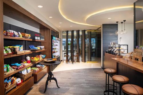 a restaurant with a table and stools in a room at Hilton Miami Aventura in Aventura