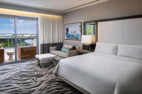 a hotel room with a large bed and a large window at Hilton Miami Aventura in Aventura