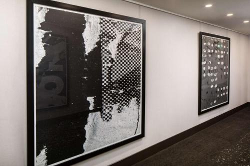 two framed pictures on a wall in a museum at Hilton Miami Aventura in Aventura
