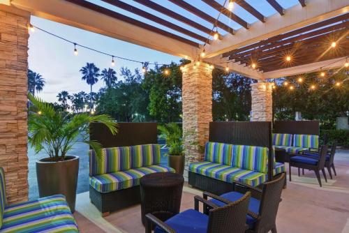 a patio with chairs and tables and lights at Home2 Suites by Hilton Miramar Ft. Lauderdale in Miramar