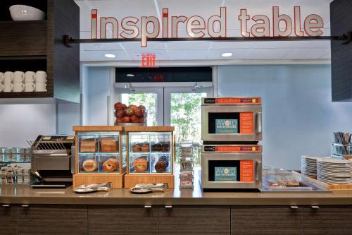 a fast food restaurant with alined table with pastries at Home2 Suites by Hilton Miramar Ft. Lauderdale in Miramar