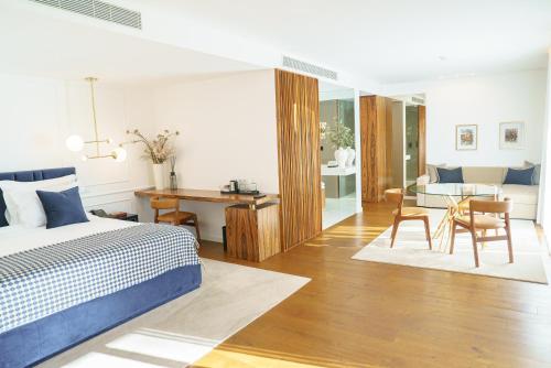 a bedroom with a bed and a dining room at Quinta de Silvalde in Santo Tirso