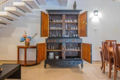 a kitchen with a cabinet with dishes on it at Spacious 4BR 4BA Family Villa wt Balcony & Lavish Garden in Ratmalana
