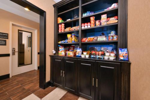 a pantry with black cabinets and food on the shelves at Hampton Inn Pecos in Pecos