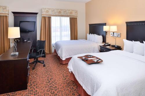 a hotel room with two beds and a desk at Hampton Inn Pecos in Pecos