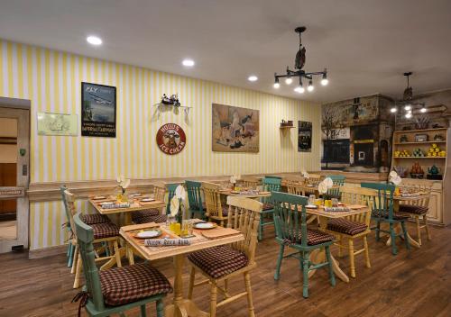a restaurant with wooden tables and green chairs at Ambassador, New Delhi - IHCL SeleQtions in New Delhi
