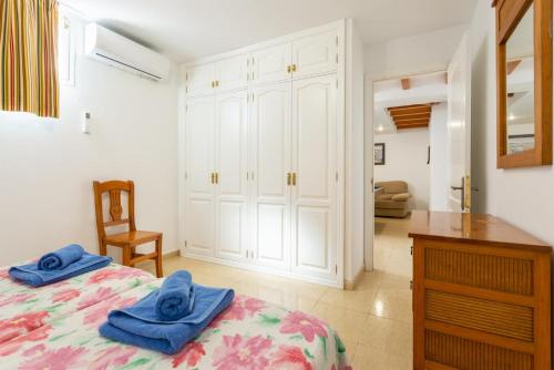 a bedroom with a bed with blue towels on it at Villa Tania in Puerto del Carmen