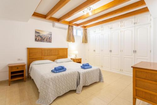 a bedroom with a bed with blue towels on it at Villa Tania in Puerto del Carmen