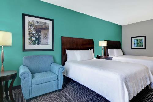 a hotel room with a bed and a chair at Hilton Garden Inn and Fayetteville Convention Center in Fayetteville