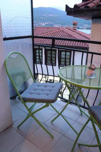 a table and chairs on a balcony with a view at Apartmani Marija in Ohrid