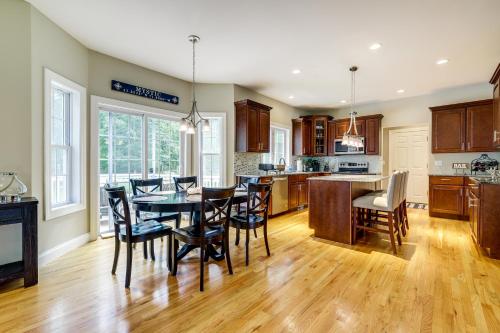 a kitchen and dining room with a table and chairs at Coastal Retreat at Mystic Seaport Heights in Mystic