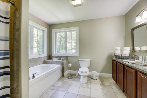 a bathroom with a tub and a toilet and a sink at Coastal Retreat at Mystic Seaport Heights in Mystic