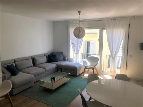 a living room with a couch and a table at Gaudi Street Apartments in Sitges