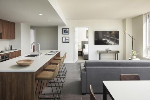 a kitchen and living room with a couch and a table at Level Seattle Downtown South Lake Union in Seattle