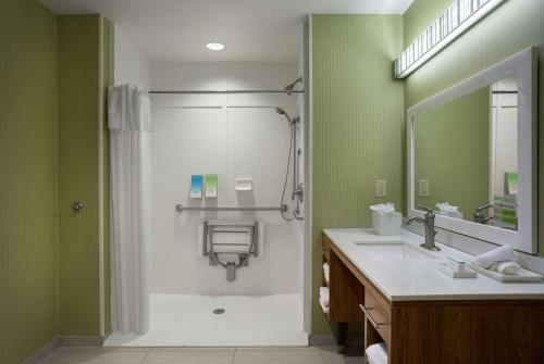 a bathroom with a shower and a sink at Home2 Suites by Hilton Greenville Airport in Greenville