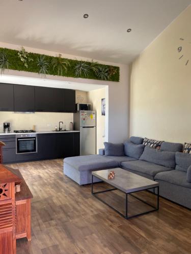 a living room with a couch and a table at Spacious modern apartments in Noord