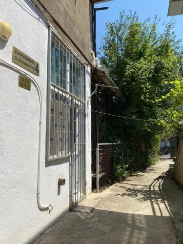 een open deur van een gebouw met een bord erop bij Eli’s home in Borjomi