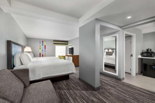 a hotel room with a bed and a mirror at Hampton Inn Greenville-Simpsonville in Simpsonville
