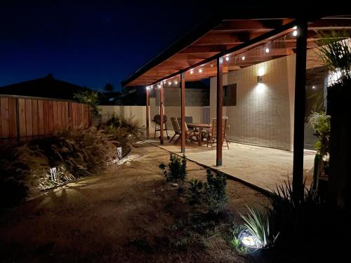a house with a patio at night with lights at Spacious modern apartments in Noord