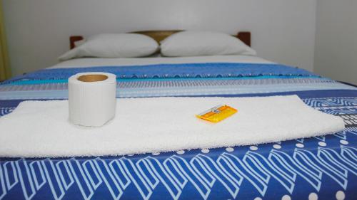 a bed with a roll of toilet paper and a napkin at Hospedaje chanari in La Merced