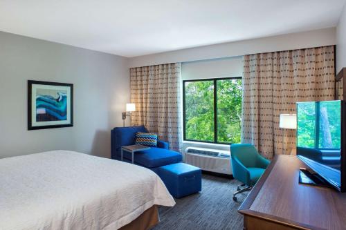 a hotel room with a bed and a desk and a chair at Hampton Inn Gulf Shores in Gulf Shores