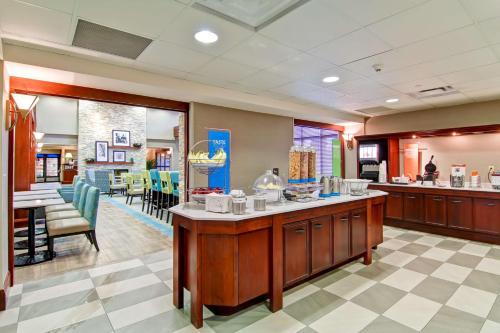a large room with a kitchen and a dining room at Hampton Inn & Suites Guelph in Guelph