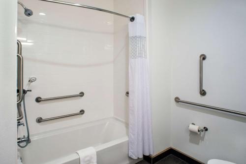 a bathroom with a shower and a shower curtain at Hampton Inn Gulf Shores in Gulf Shores