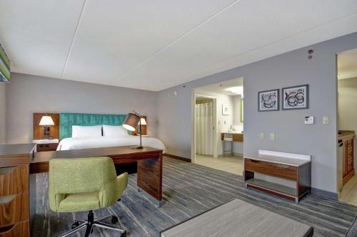 a hotel room with a bed and a desk at Hampton Inn & Suites Guelph in Guelph