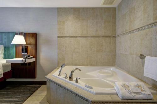 a bathroom with a bath tub in a room at Hampton Inn & Suites Guelph in Guelph