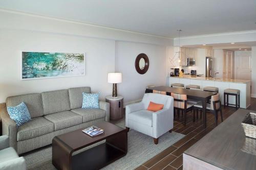 a living room with a couch and a dining room at Hilton Grand Vacations Club Ocean Oak Resort Hilton Head in Hilton Head Island