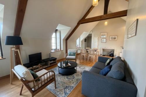 a living room with a blue couch and chairs at Bright apartment near the heart of Vannes in Vannes
