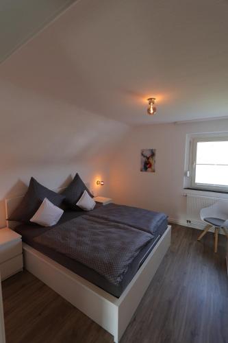 a bedroom with a bed and a window at Ferienhaus Alte Maßschneiderei in Schleiden