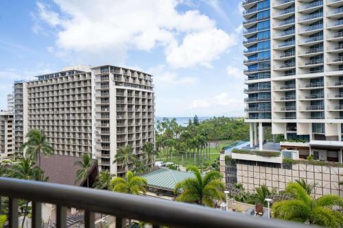 a view of two tall buildings from a balcony at Embassy Suites by Hilton Waikiki Beach Walk in Honolulu