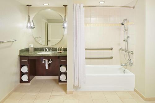a bathroom with a tub and a sink at Hilton Grand Vacations Club Grand Waikikian Honolulu in Honolulu