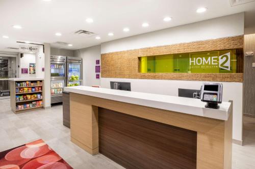 a lobby of a home store with a counter at Home2 Suites by Hilton Houston Bush Intercontinental Airport Iah Beltway 8 in Houston