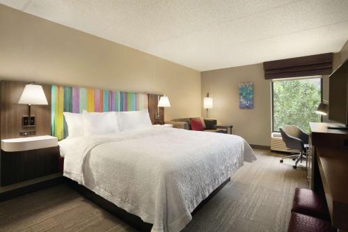 a hotel room with a bed and a window at Hampton Inn - Houston/Brookhollow in Houston