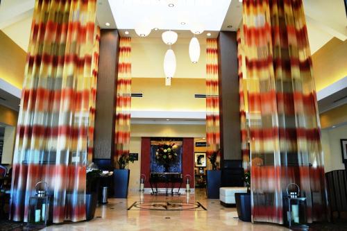 a lobby with red and gold curtains in a building at Hilton Garden Inn Houston West Katy in Katy