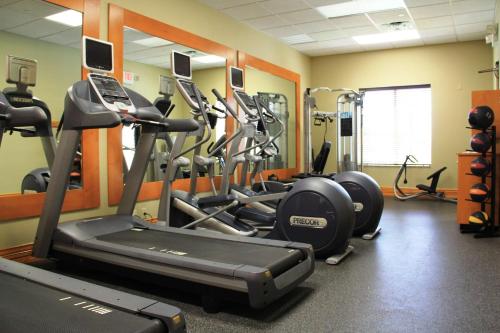 a gym with several tread machines in a room at Hilton Garden Inn Houston West Katy in Katy