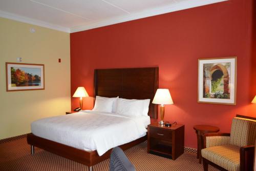 a hotel room with a bed and a chair at Hilton Garden Inn Houston West Katy in Katy