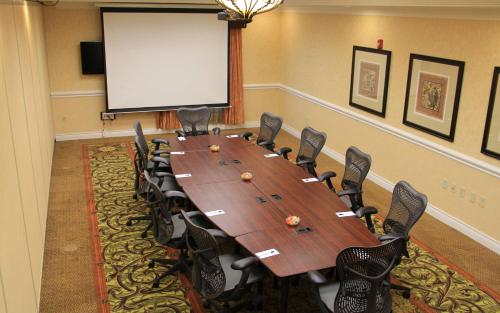 a conference room with a large wooden table and chairs at Hilton Garden Inn Houston West Katy in Katy